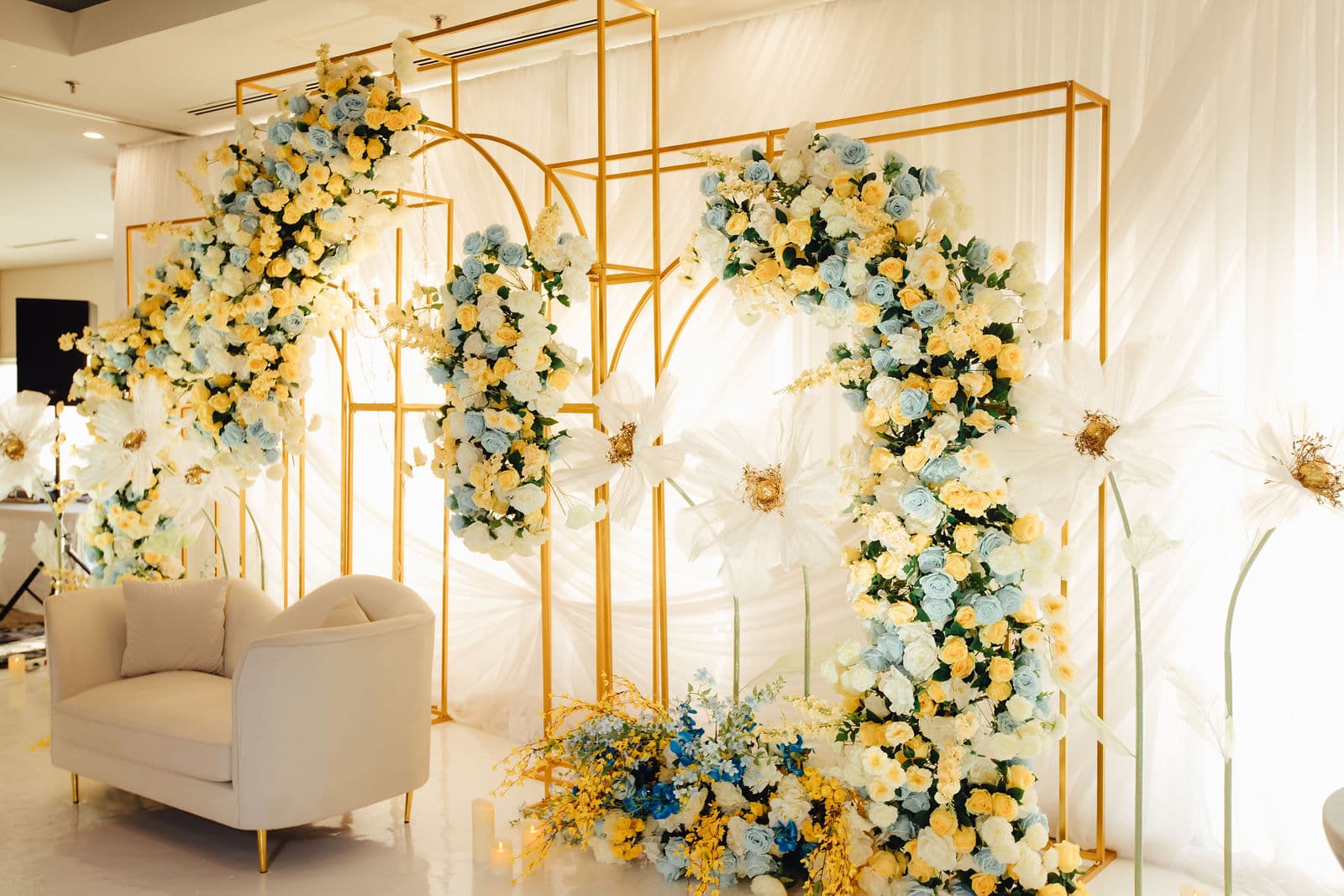 Blue and yellow floral wedding backdrop with seating