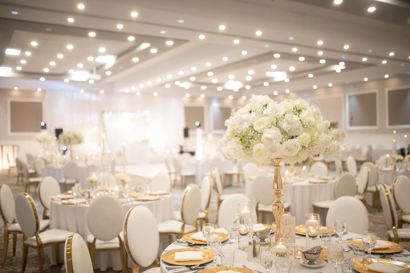 Wedding reception tables with white rose centrepieces